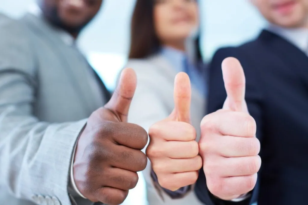 Three people giving thumbs up