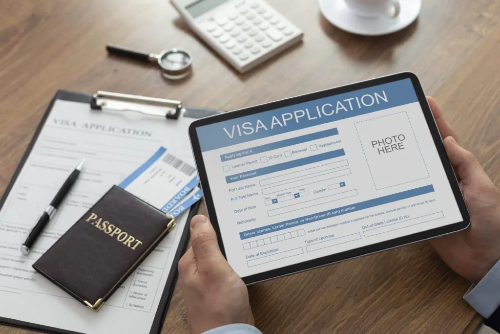 Filling out visa application on tablet with passport