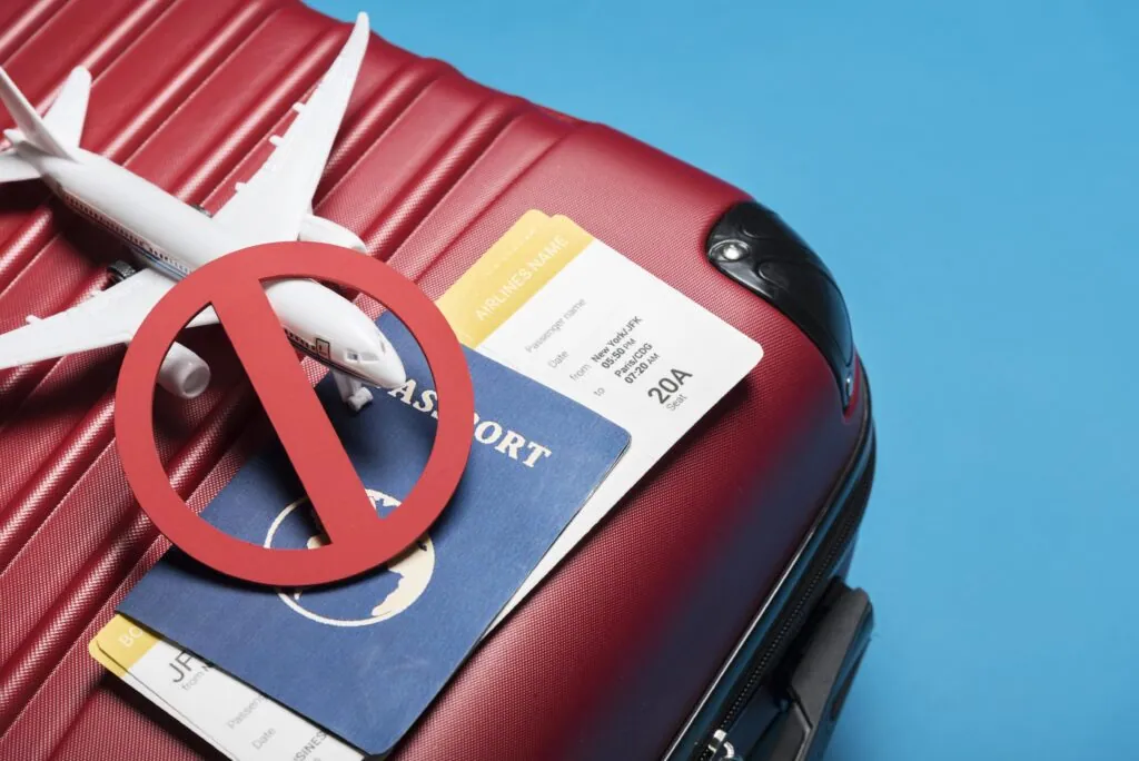 Travel restricted items on red suitcase