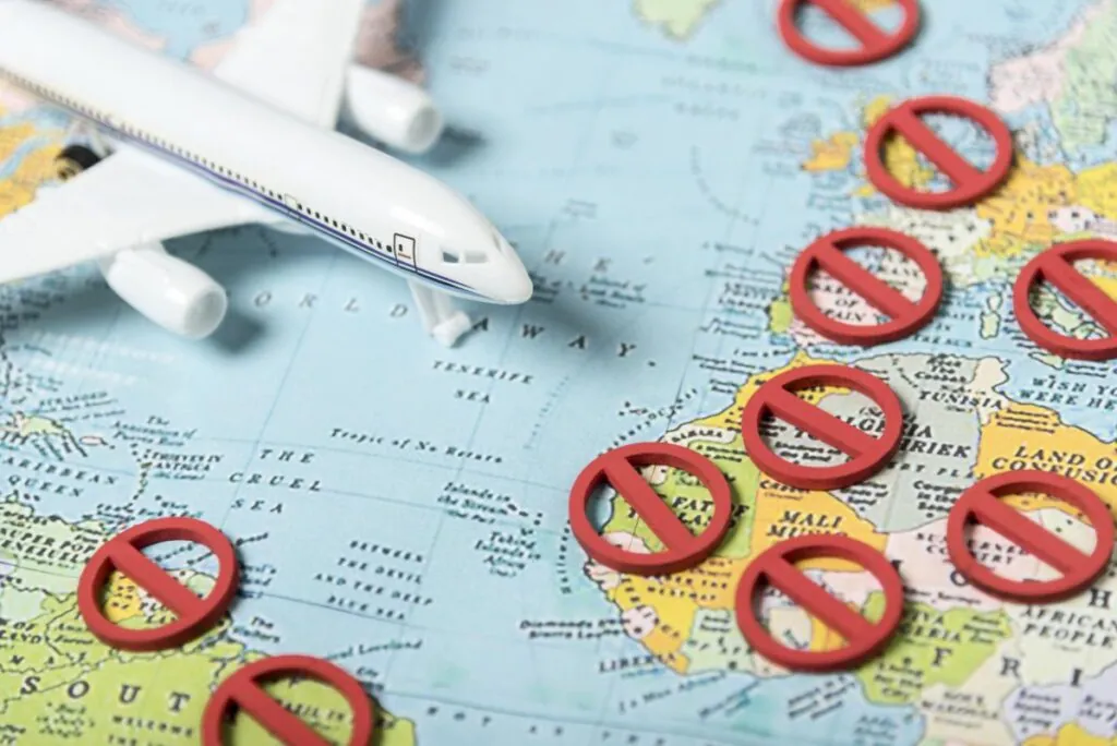 Toy airplane on a map with red prohibition signs