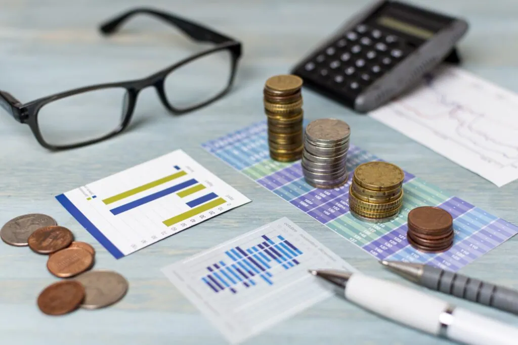 Coins and financial charts on a desk