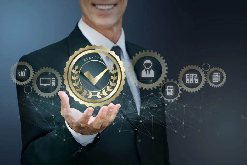 Businessman holding a floating "Standard" badge with gears