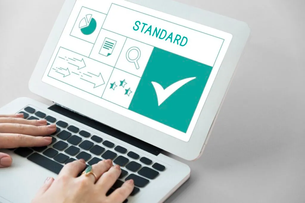 Person typing on laptop with "Standard" on screen