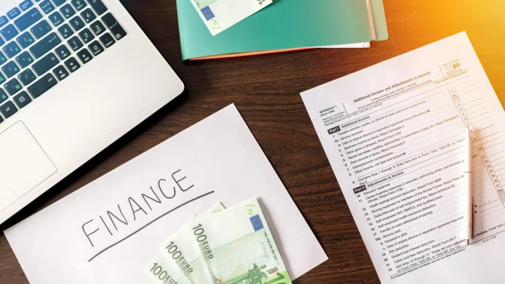 Finance documents, tax form, and cash
