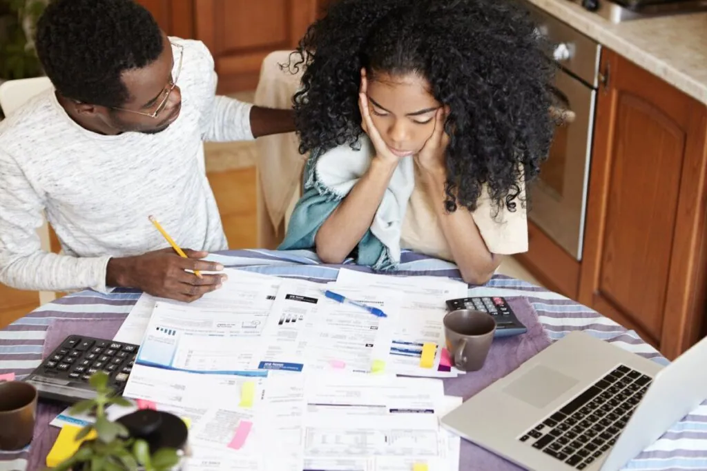 Couple stressed over bills at the kitchen table