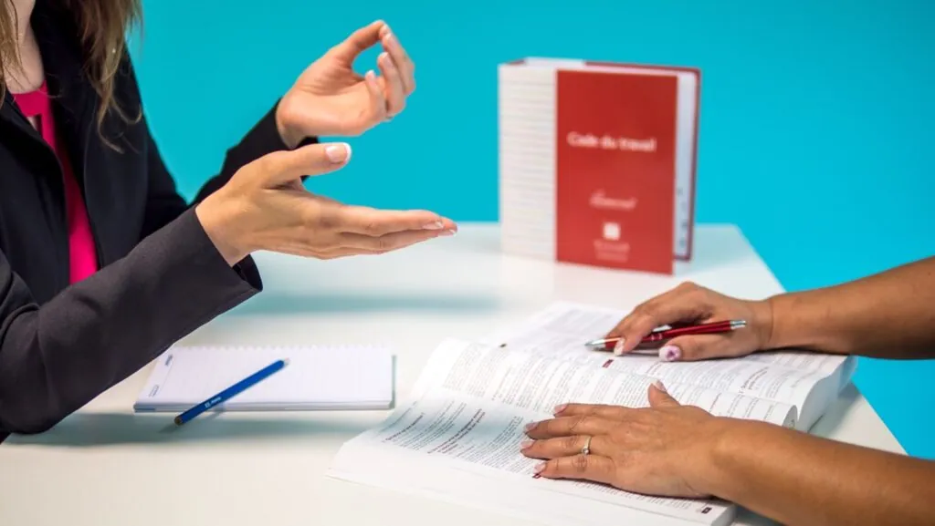 Two people discussing and reviewing a document
