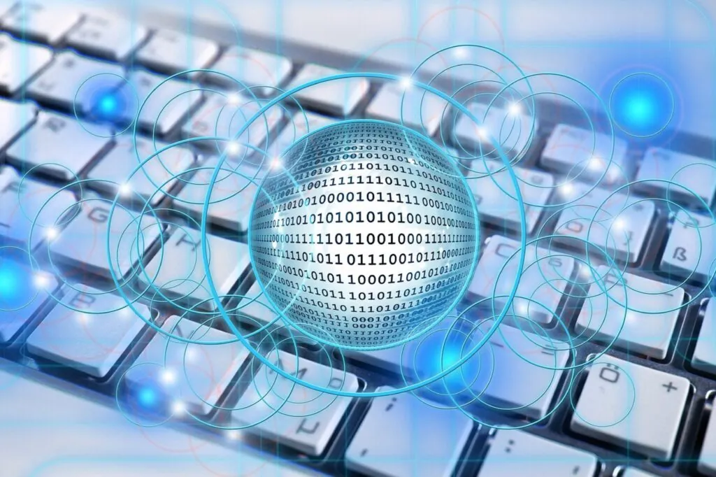 Binary code sphere over computer keyboard background