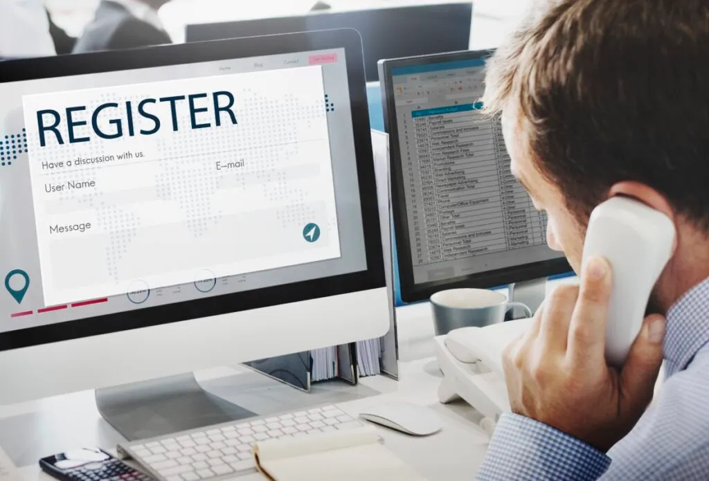 Person on a phone call working on a registration form