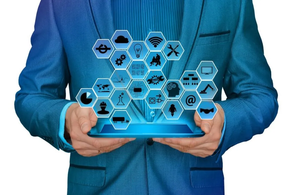 Person holding a tablet displaying hexagonal icons