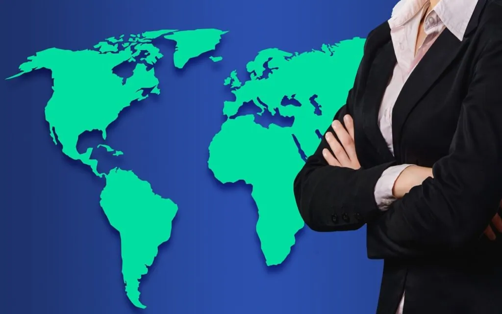 Businessperson standing in front of world map