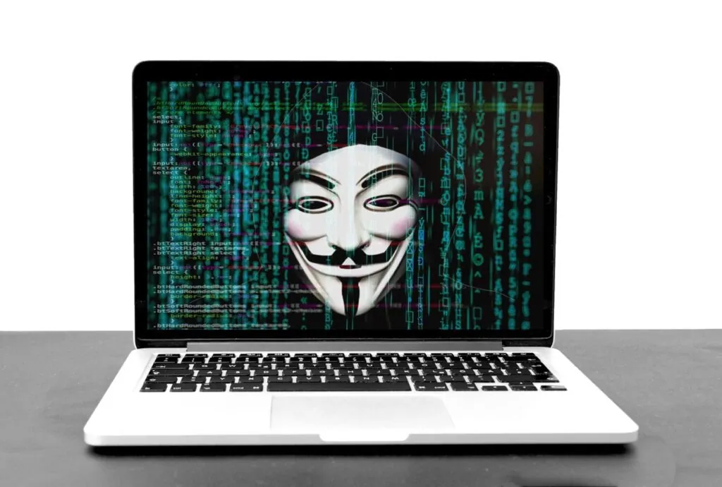 Laptop screen displaying a hacker's mask