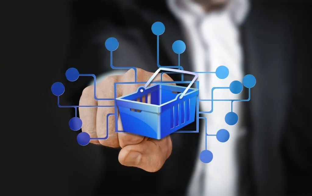 Hand pointing at digital shopping cart icon