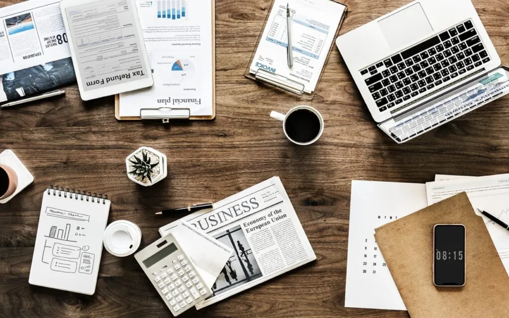 Business documents and electronics on a wooden desk
