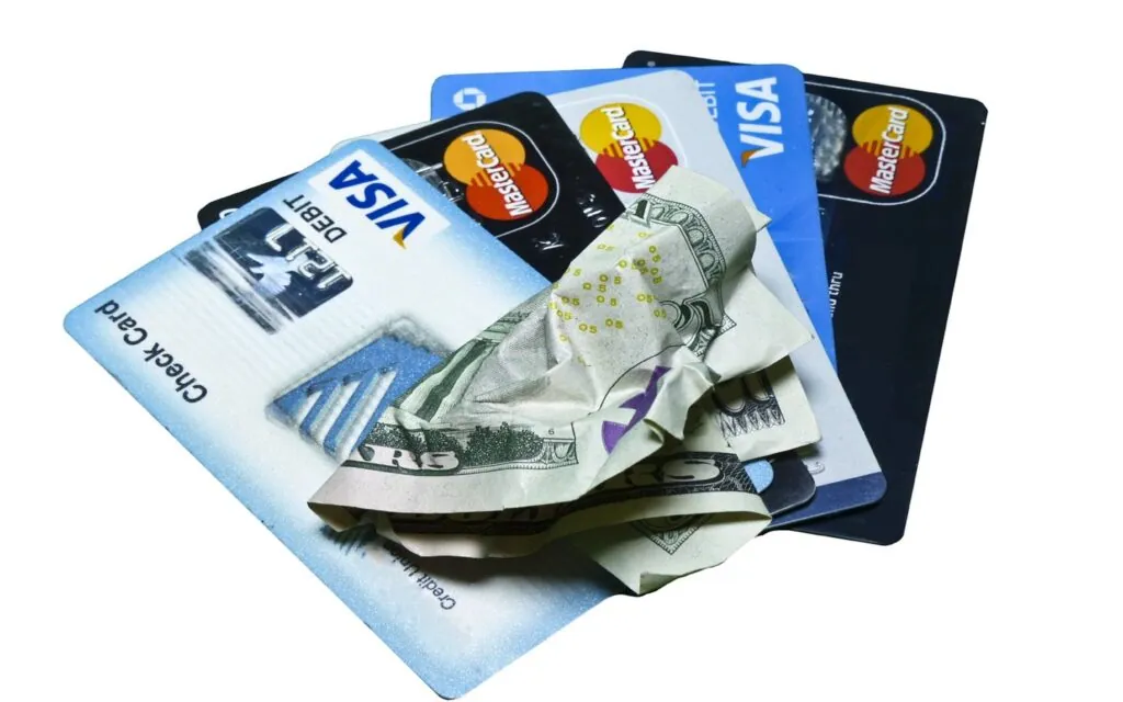 Crumpled cash and credit cards together
