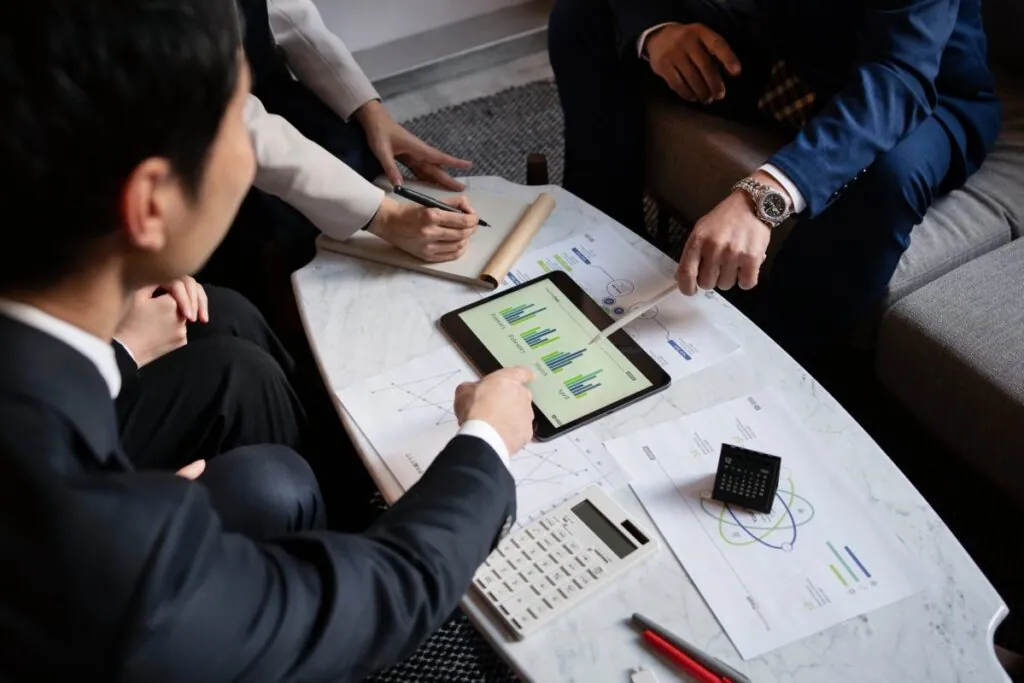 Group discussing financial data on a tablet