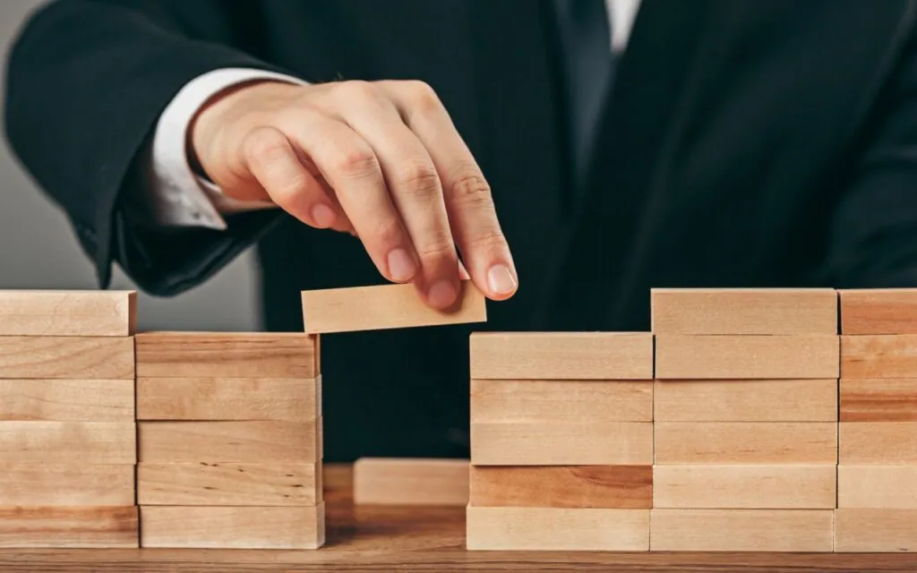 Person placing wooden block to bridge gap