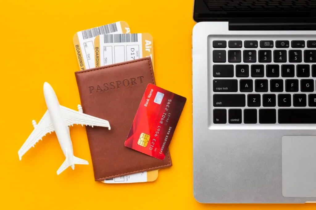 Travel essentials with passport and laptop