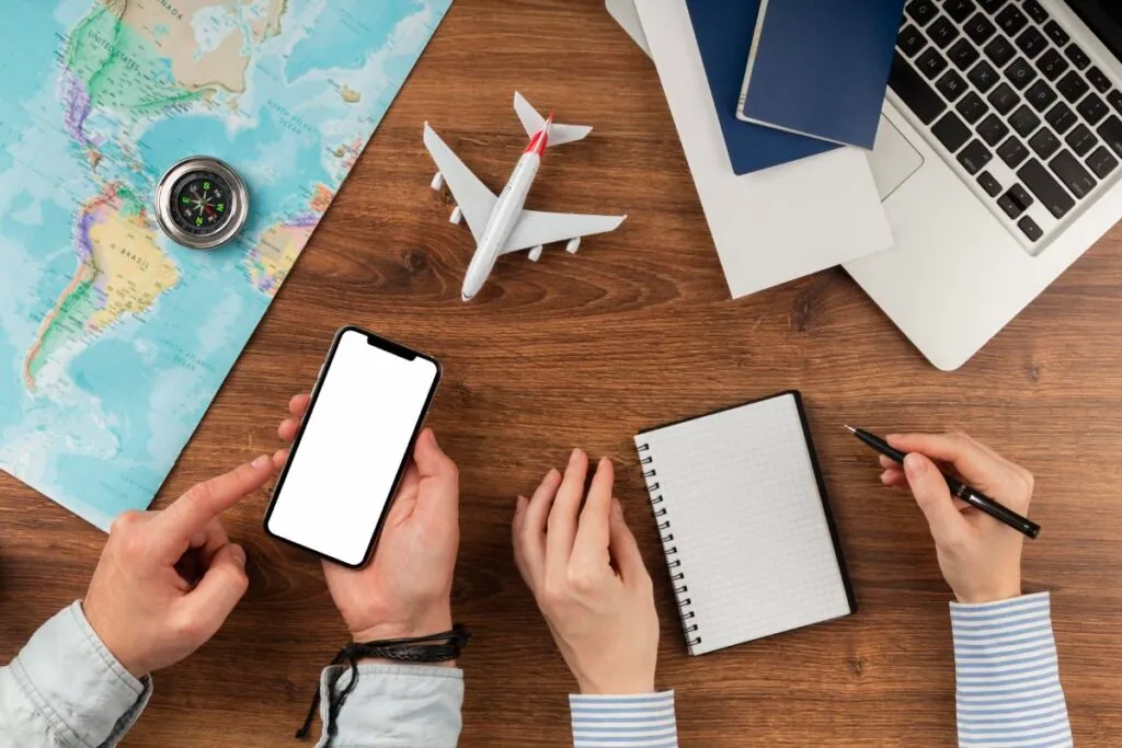 Travel planning with map phone and notebook