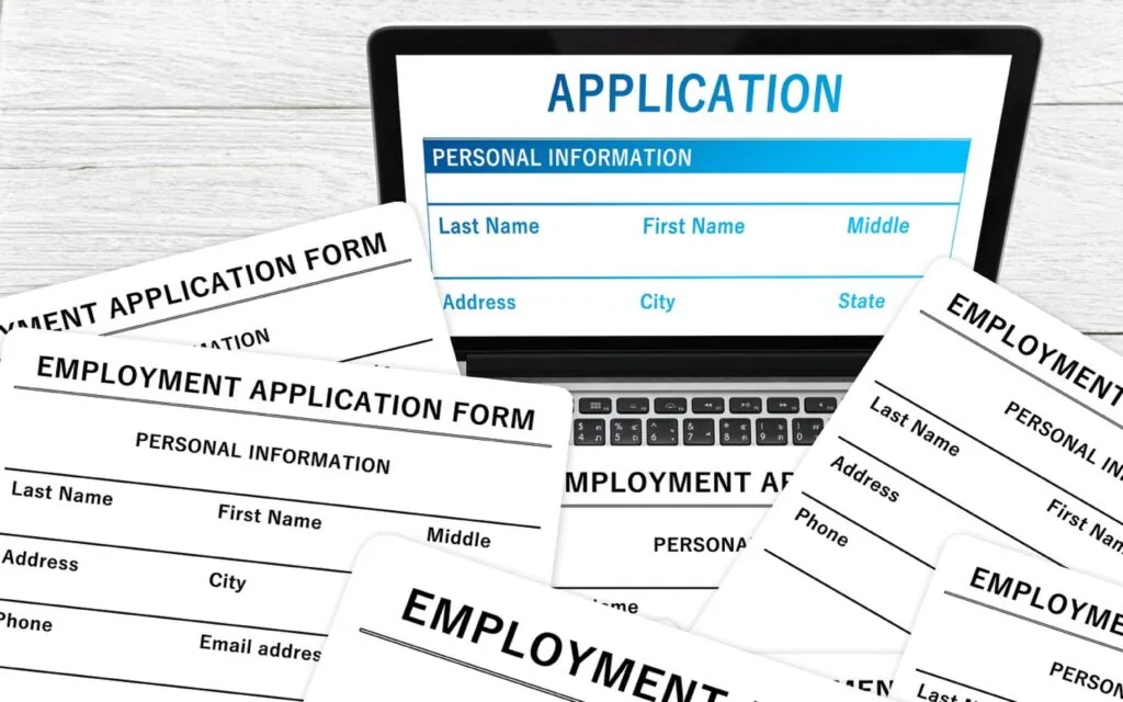 Multiple employment application forms on a laptop screen