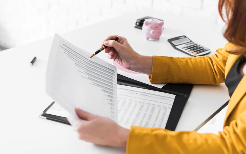 Person analyzing financial graphs at a desk