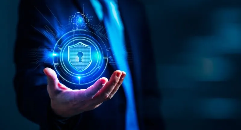 Hand holding glowing lock with circuit pattern
