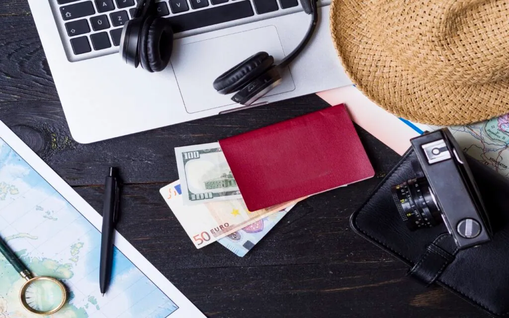 Travel essentials including laptop passport money and camera