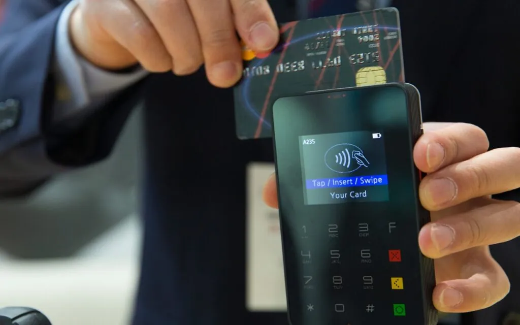 Person swiping a credit card on a reader
