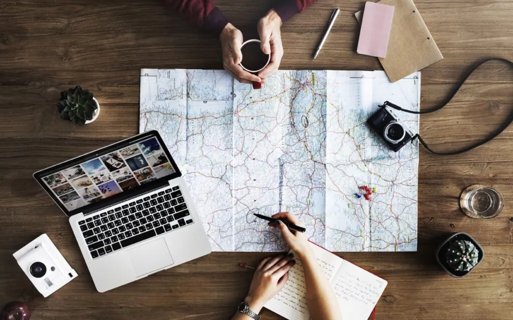 Planning a trip with map and laptop