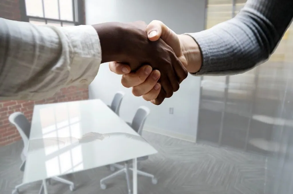 Two people shaking hands in an office