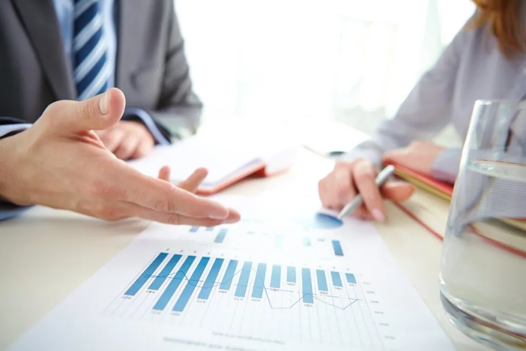 Businesspeople discussing over financial charts