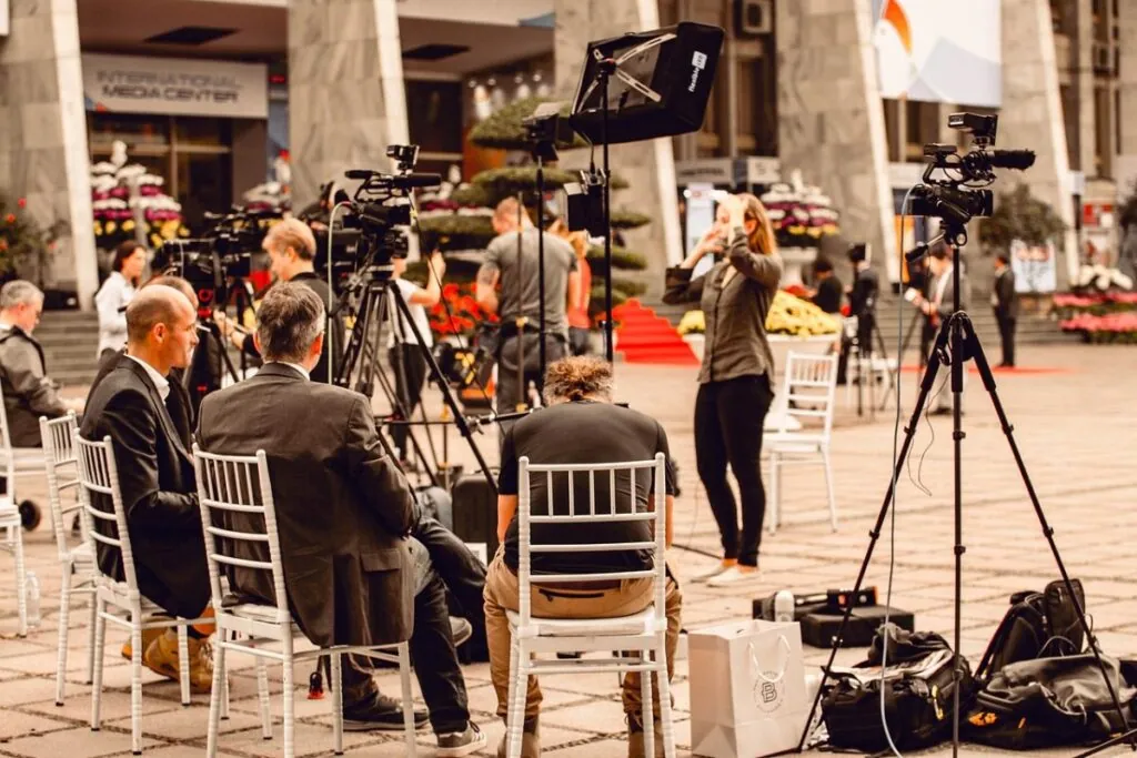 Media crew setting up cameras at an event