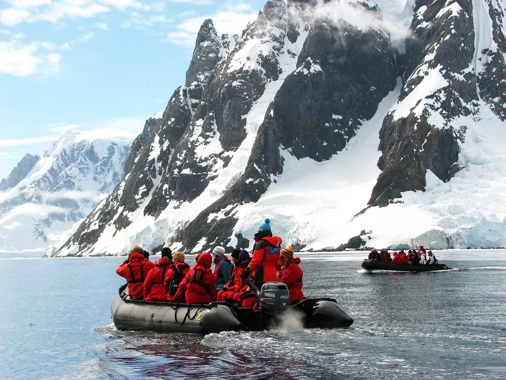Tourists on boats exploring icy Antarctic waters