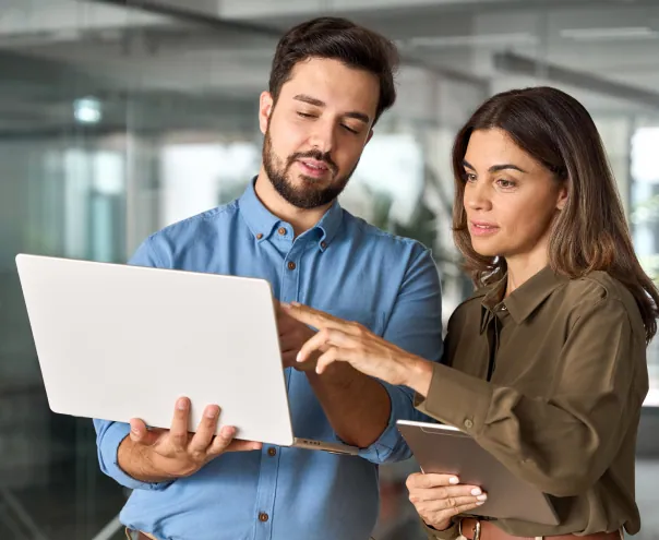 Man and woman discussing work on a laptop